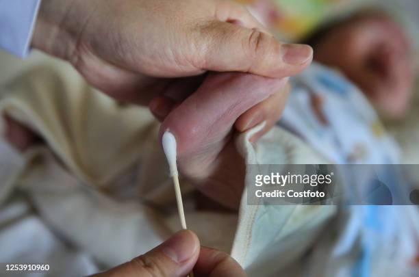 Pan Shuihua, a nurse at the 14ninth Hospital, takes blood for newborn babies to be screened for genetic metabolic diseases in Lianyungang city,...