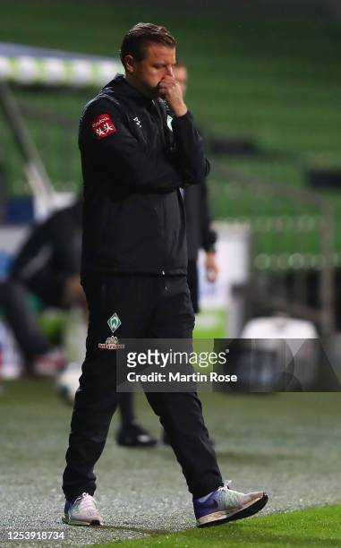 Florian Kohfeldt, head coach of Bremen ponders during the Bundesliga playoff first leg match between Werder Bremen and 1. FC Heidenheim at Wohninvest...