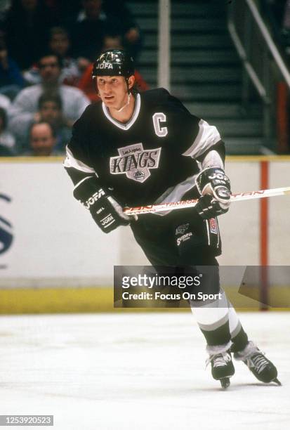 Wayne Gretzky of the Los Angeles Kings skates against the New Jersey Devils during an NHL Hockey game circa 1991 at the Brendan Byrne Arena in East...
