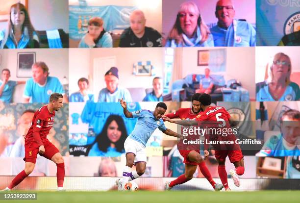 Raheem Sterling of Manchester City is fouled by Joe Gomez and Georginio Wijnaldum of Liverpool and a penalty is later awarded during the Premier...
