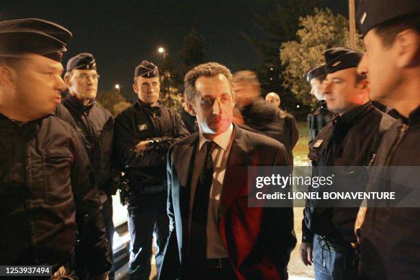 French Interior minister Nicolas Sarkozy speaks with policement during a visit in "Le Mirail", a tough neighbourhood of Toulouse, west southern...