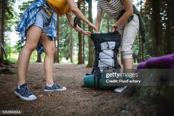 mountain hikers unpacking a backpack at their camp - open rucksack stock pictures, royalty-free photos & images