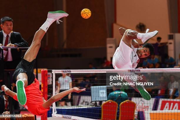 Indonesia's Diky Apriyadi jumps for the ball during the men's sepaktakraw doubles match against Myanmar at the 32nd Southeast Asian Games in Phnom...