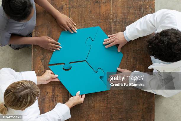 professionals assembling 3 par puzzle piece, aerial view - part of stock pictures, royalty-free photos & images