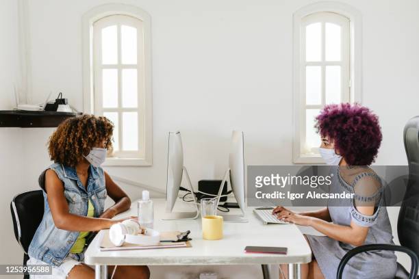 Covid-19: Women working in the office wearing a face mask