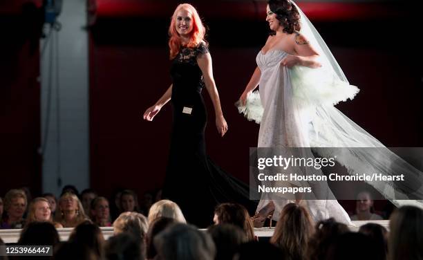 Damsel White Label designer Natalie Harris left, walks with a model on the runway after the Damsel White Label bridal fashion show at the 30th...