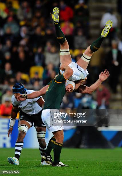 Flanker Schalk Burger of the Springboks is upended at a restart despite the supoport from teammate Heinrich Brussow during the IRB 2011 Rugby World...