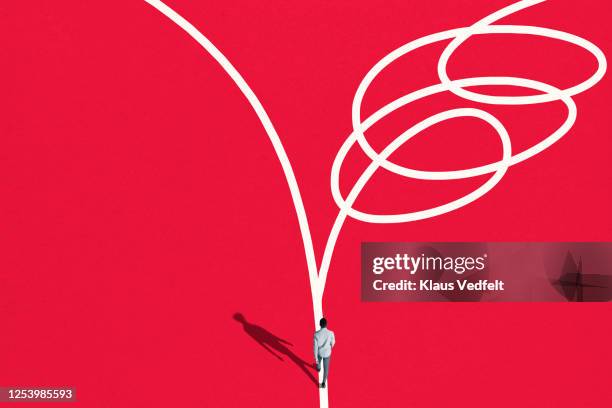 rear view of young man walking towards detour - simplicity abstract stock pictures, royalty-free photos & images