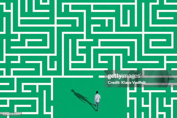 high angle view of man surrounded by white maze - labirinto imagens e fotografias de stock