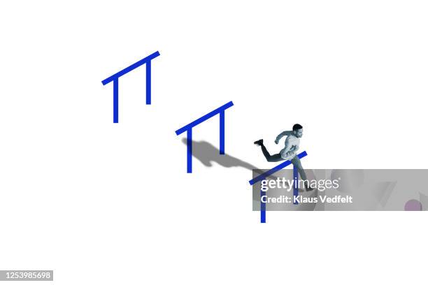 man jumping over obstacle while running in race - design sprint stock pictures, royalty-free photos & images