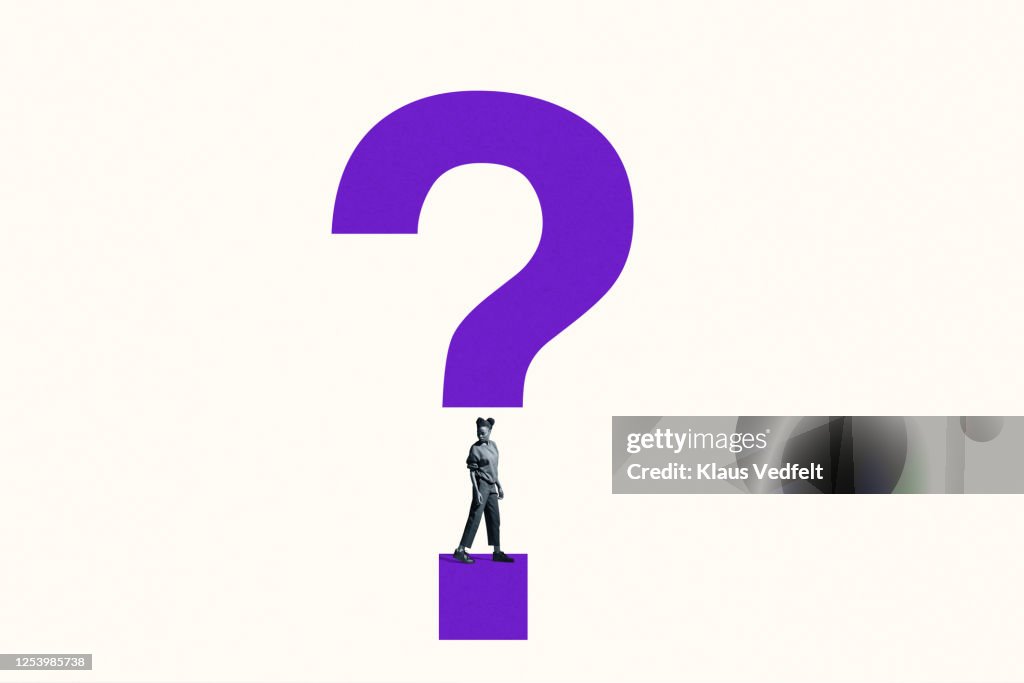 Woman looking over shoulder under question mark