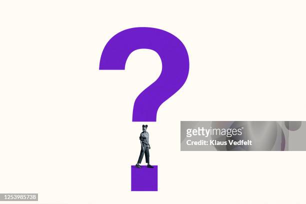 woman looking over shoulder under question mark - q and a stock pictures, royalty-free photos & images