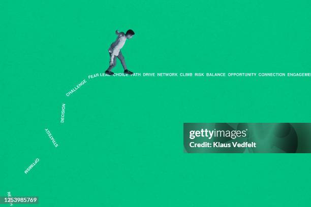 side view of young man walking on words - overcome fear stock pictures, royalty-free photos & images