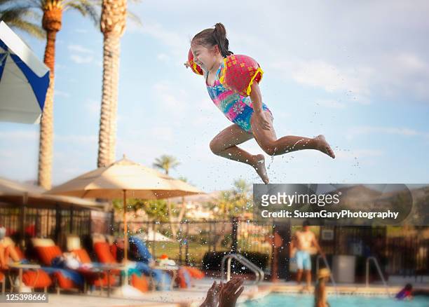 super toddler girl flying in air - henderson nevada photos et images de collection