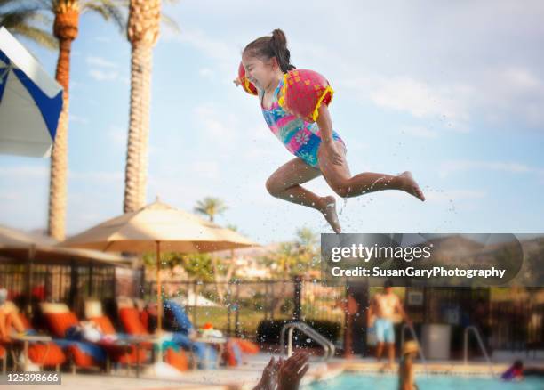 super toddler girl flying in air - kids in swimming pool stock pictures, royalty-free photos & images