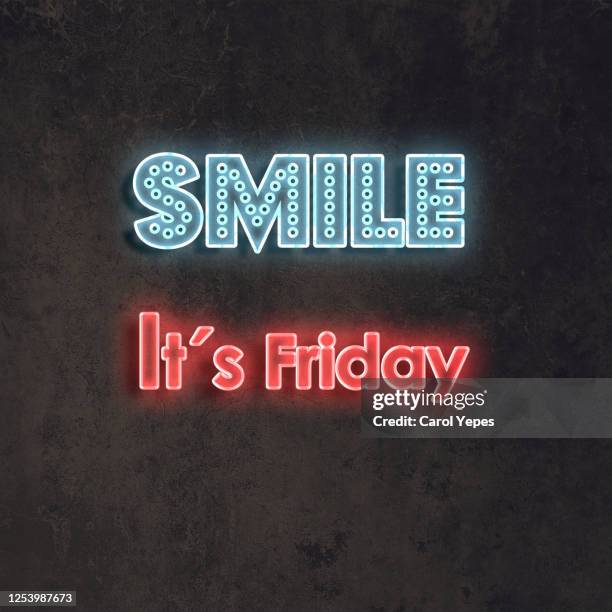 smile it´s friday text in neon lights and black background - fridy stock pictures, royalty-free photos & images