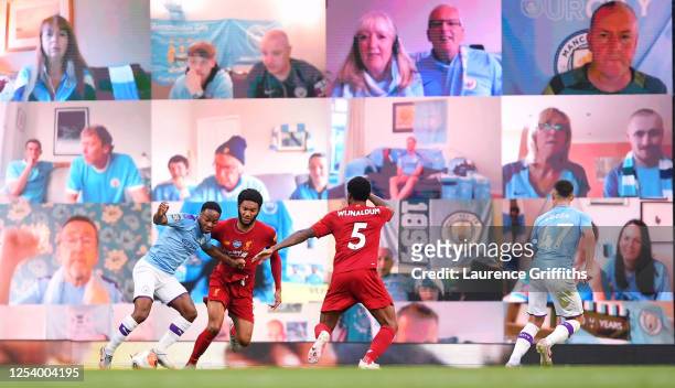 Raheem Sterling of Manchester City is fouled in the penalty area by Joe Gomez of Liverpool as fans watch on the big screen during the Premier League...