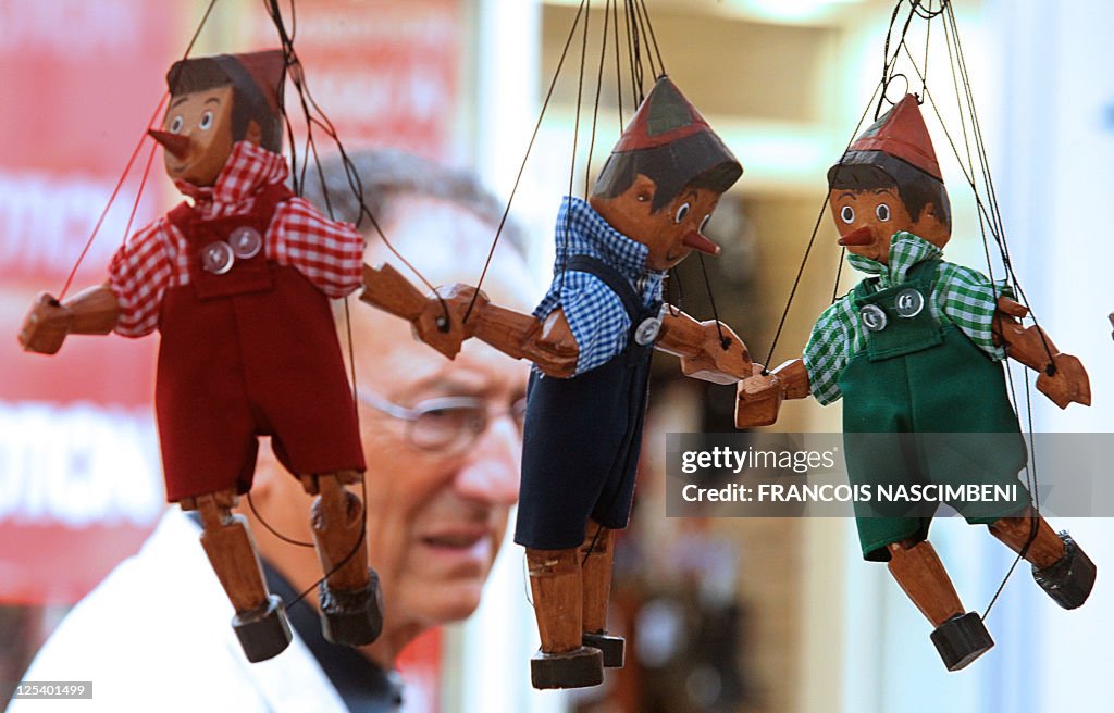A man passes by marionettes on September