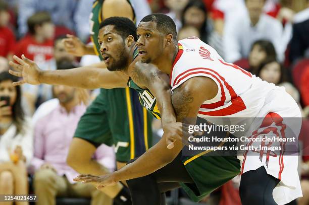 Utah Jazz forward Derrick Favors left, and Houston Rockets forward Terrence Jones right, during the first quarter of NBA game action at the Toyota...