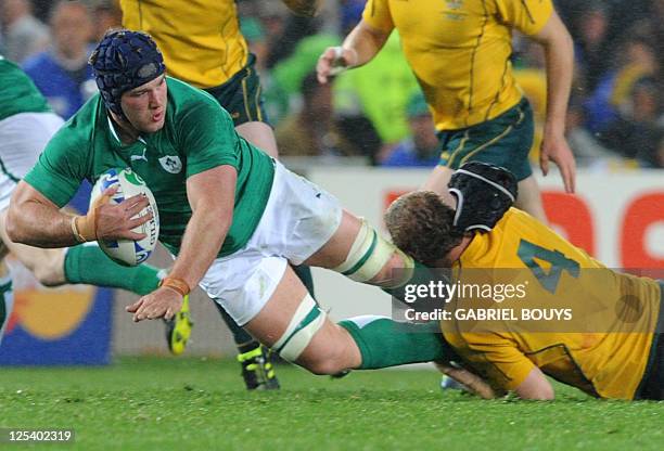 Ireland's No8 Jamie Heaslip is tackled by Australia's lock Dan Vickerman during the 2011 Rugby World Cup pool C match Australia vs Ireland at Eden...