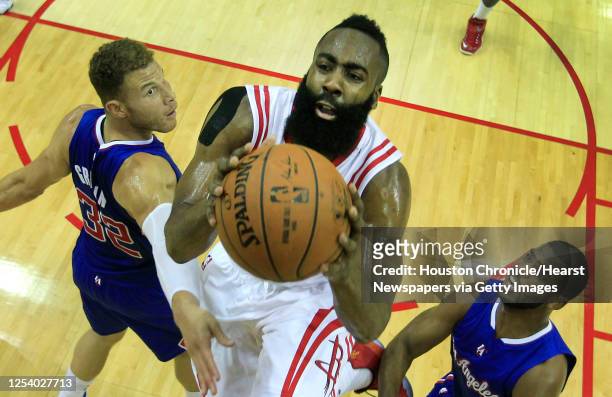 Houston Rockets guard James Harden drives in for a layup past Los Angeles Clippers forward Blake Griffin and Chris Paul during the first half of Game...