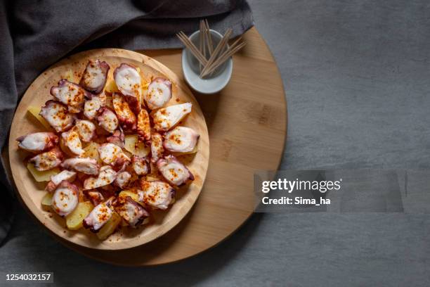 photo of octopus with boiled potatoes aka "pulpo a feira", typical spanish dish - galicia stock pictures, royalty-free photos & images