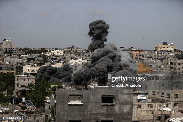 Smoke rises after the building belonging to Palestinian Taha family in Jabalia Camp hit by Israeli forces in Gaza City, Gaza on May 12, 2023. Israeli...