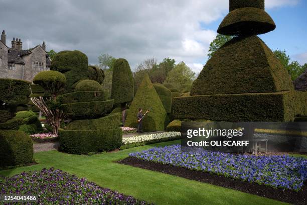 Gardener works at preparing the world's oldest topiary garden in the grounds of Levens Hall, an Elizabethan stately home, near Kendal in north-west...