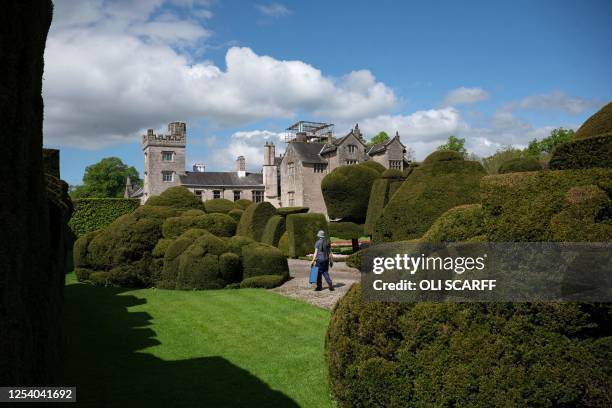 Gardener walks through the world's oldest topiary garden in the grounds of Levens Hall, an Elizabethan stately home, near Kendal in north-west...