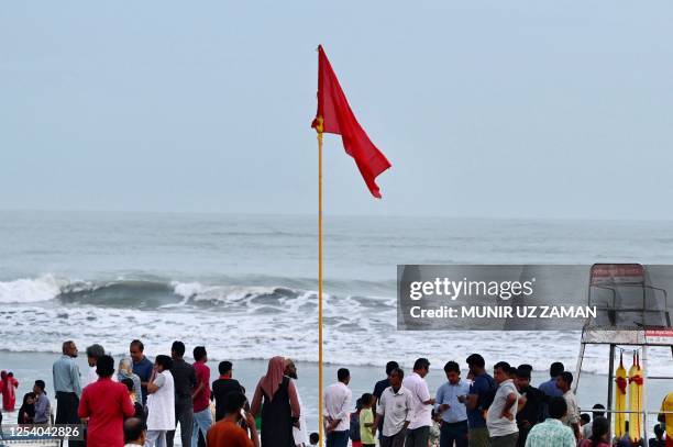 People gather at beach in Cox's Bazar on May 12 ahead of the landfall of cyclone Mocha. Myanmar and Bangladesh deployed thousands of volunteers and...