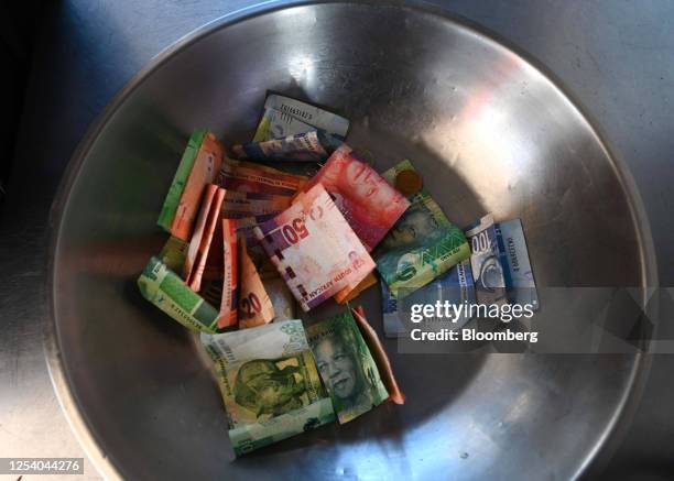 Bowl of South African rand banknotes at a street vendor's stall in the Sandton district of Johannesburg, South Africa, on Friday, May 12, 2023....