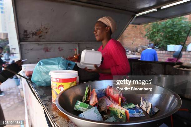 Bowl of South African rand banknotes at a street vendor's stall in the Sandton district of Johannesburg, South Africa, on Friday, May 12, 2023....