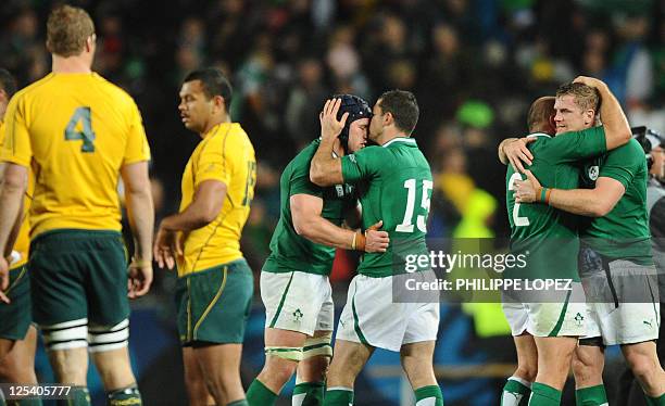 Ireland's players, including Ireland's full back Rob Kearney and hooker Rory Best react next to Australian Wallaby players full back Kurtley Beale...