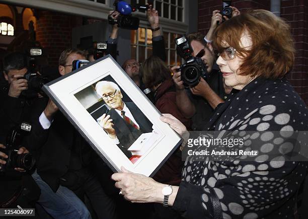 Rose-Marie von Buelow, widow of German comedian Vicco von Buelow, looks on a picture of her husband prior to the funeral service at the St. Gotthardt...