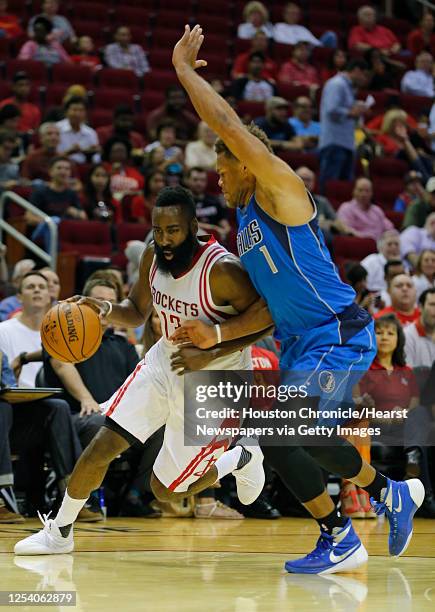 Houston Rockets guard James Harden left, and Dallas Mavericks guard Justin Anderson during first half NBA preseason game action at the Toyota Center...