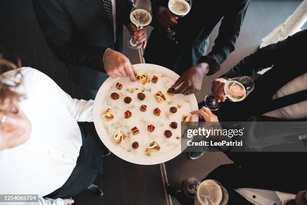 business people enjoying an aperitif before dining in a luxury restaurant - elegant dinner party stock pictures, royalty-free photos & images