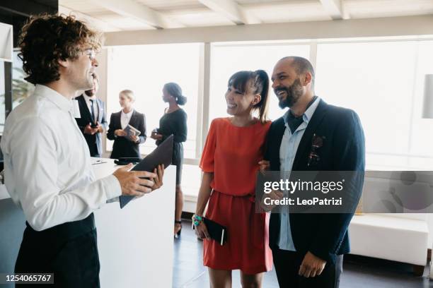 wait staff of a luxury restaurant is welcoming business guests - entering restaurant stock pictures, royalty-free photos & images