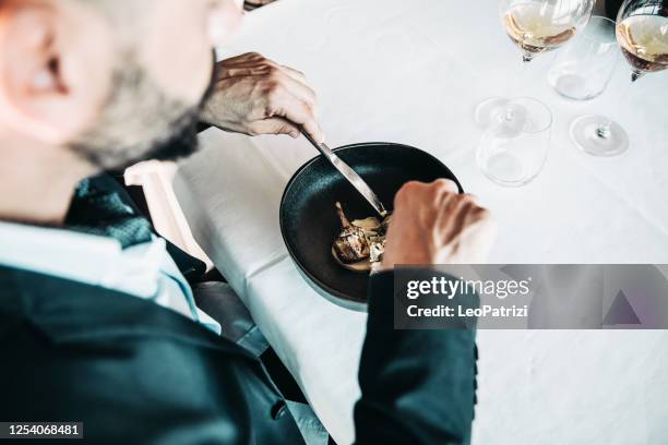 man eating in a gourmet luxury restaurant - table manners stock pictures, royalty-free photos & images