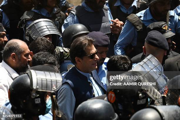 Police cammandos escort former Pakistan's Prime Minister Imran Khan as he arrives at the high court in Islamabad on May 12, 2023. Former Pakistan...