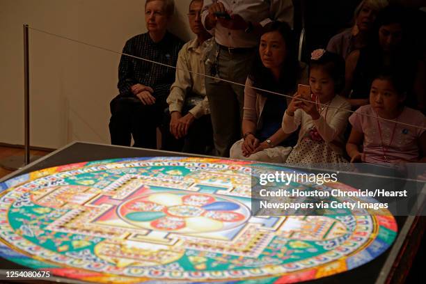 Mandala sand painting with millions of grains of sand are painstakingly laid into place in order to purify and heal the environment and its...