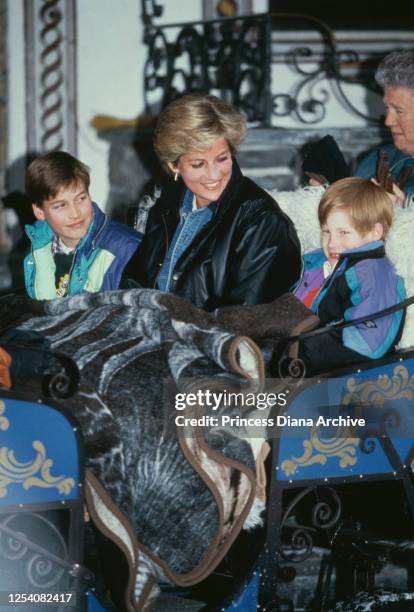 Diana, Princess of Wales riding in a traditional sleigh with Prince William and Prince Harry during a skiing holiday in Lech, Austria, 30th March...