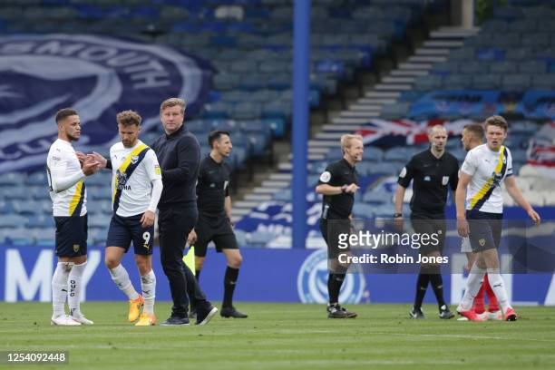 Karl Robinson of Oxford United pushes away his players Marcus Browne and Matty Taylor from confronting Referee Gavin Ward at half-time during the Sky...