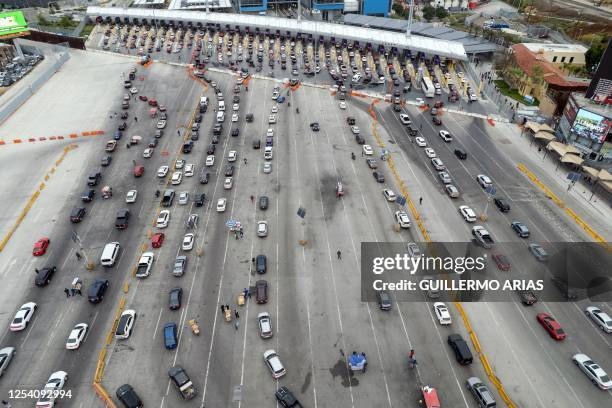 Aerial view of cars lining up to cross to the US at the San Ysidro Port of Entry in Tijuana, Baja California state, Mexico on May 12, 2023. The...