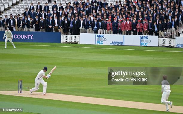 Eton schoolboys look on from the grandstand as Harrow bat during the Eton v Harrow cricket match at Lord's Cricket Ground in London on May 12, 2023....