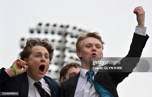 Harrow schoolboys cheer on their team from the grandstand during the Eton v Harrow cricket match at Lord's Cricket Ground in London on May 12, 2023....