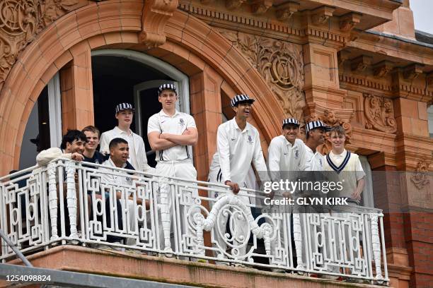 Harrow schoolboys look on from the team balcony ahead of the Eton v Harrow cricket match at Lord's Cricket Ground in London on May 12, 2023. The...