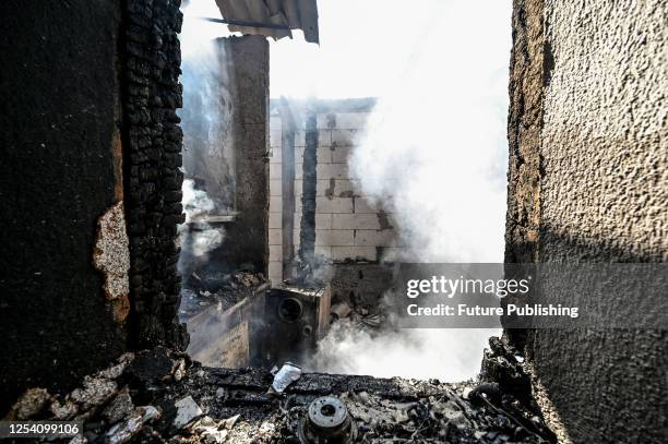 The fire-stricken premises of a house destroyed in the Russian MLRS attack are seen in Malokaterynivka, Zaporizhzhia Region, southeastern Ukraine. As...