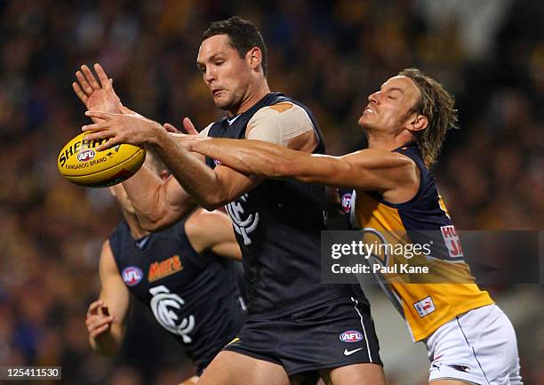 Mark Nicoski of the Eagles tackles Robert Warnock of the Blues during the AFL First Semi Final match between the West Coast Eagles and the Carlton...