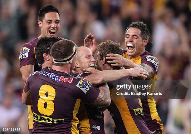 Darren Lockyer of the Broncos celebrates victory with team mates after kicking the winning field goal in gold point extra time during the NRL second...