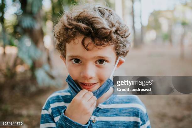 child removing face protection mask - sickness absence stock pictures, royalty-free photos & images